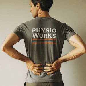 Man clutching her lower back due to pain.