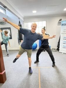Participant practising balance stepping exercises during a physiotherapist-supervised falls prevention session at PhysioWorks Clayfield