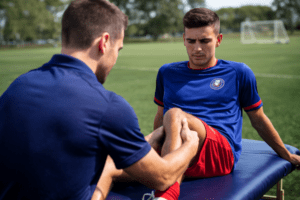 Brighton Bulldogs physio assessing knee of young football player