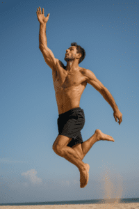 Athlete performing a high jump during sport, showing movement patterns linked to jumping injuries