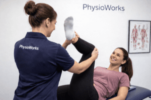 Stretching exercises with female physiotherapist assisting lower limb flexibility