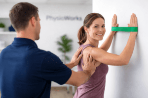 scapular stabilisation exercises with physiotherapist guiding shoulder blade control