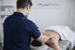 Soft tissue massage Brisbane with physiotherapist treating upper back on table