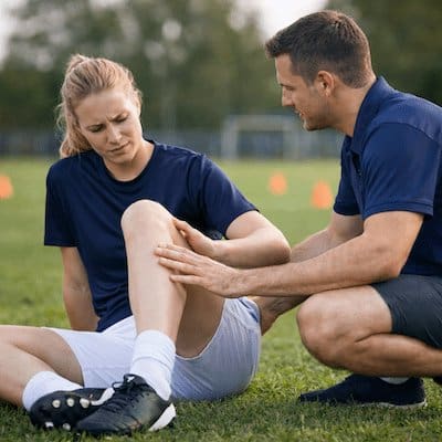 Common football injuries physiotherapy assessment of female player with knee pain on field