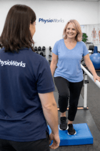 Neurological rehabilitation balance training with exercise physiologist assisting patient