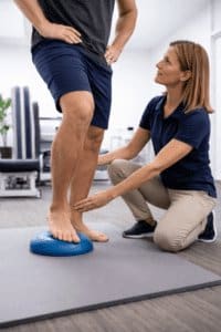 foot pain treatment physiotherapist guiding heel and arch strengthening exercise