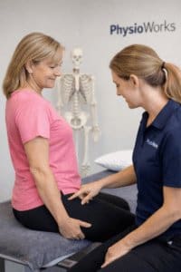 gluteal tendinopathy treatment: physiotherapist pointing to lateral hip