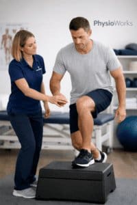 Injury rehabilitation physiotherapy guiding single-leg step-down exercise for knee and lower limb recovery