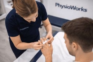 Sprained finger buddy taping by physiotherapist