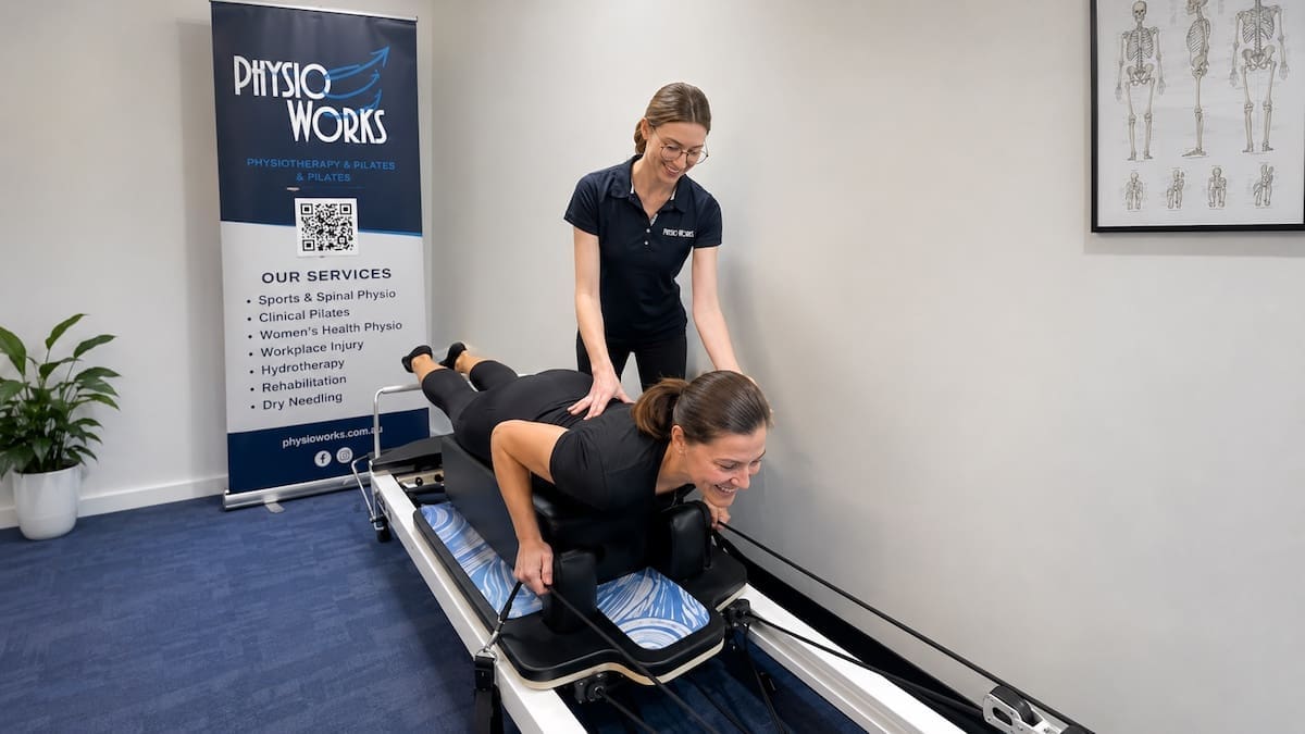 Reformer Pilates session coached by physiotherapist for trunk control