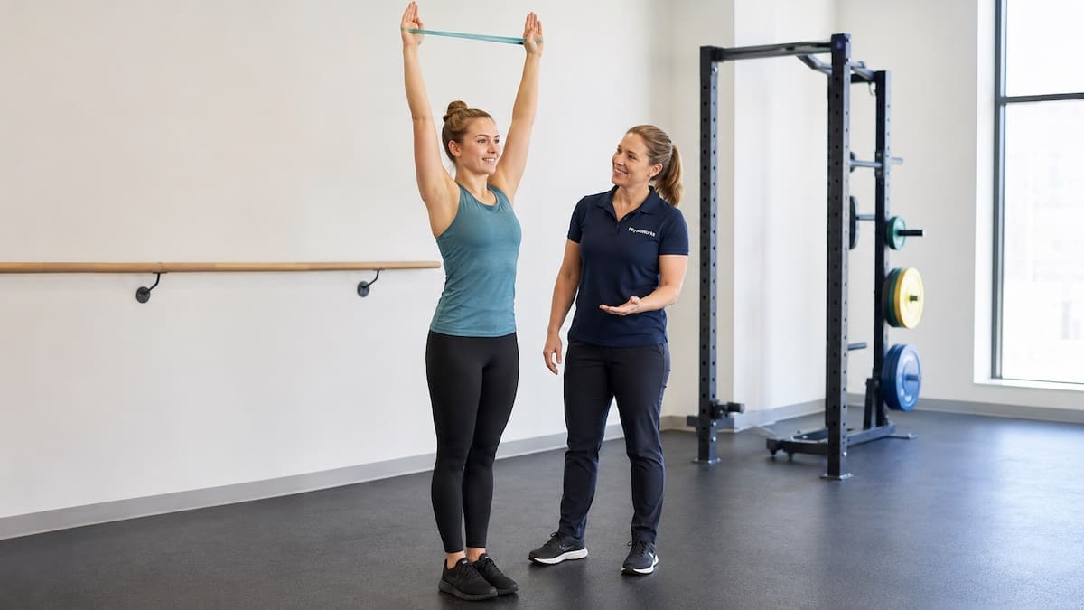 Competitive Diving Injury Rehabilitation Physiotherapist supervising overhead shoulder and trunk control rehabilitation for competitive diving